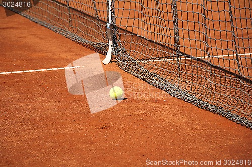 Image of Tennis ball in front of the net