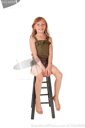 Image of Girl sitting on high chair.
