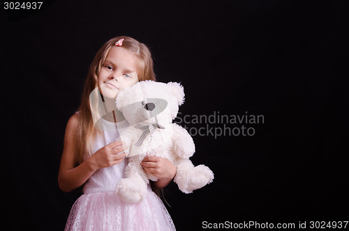 Image of Portrait of happy girl with a soft bear