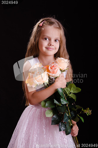 Image of Five-year girl with a bouquet of flowers