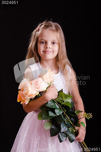 Image of Happy five year old girl with a bouquet of flowers
