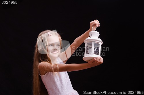 Image of Five-year girl with candlestick in the hands of