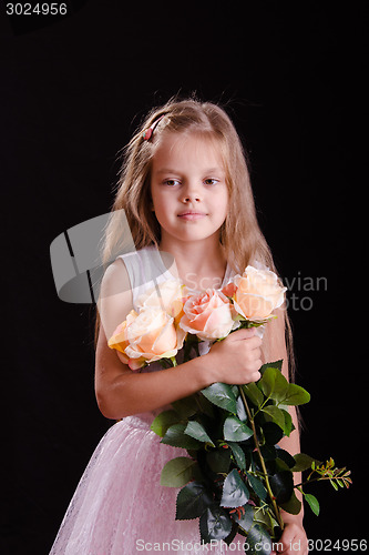 Image of Sad five year old girl with a bouquet of flowers