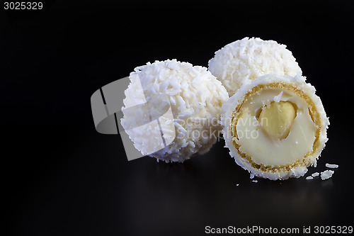 Image of coconut balls on black background