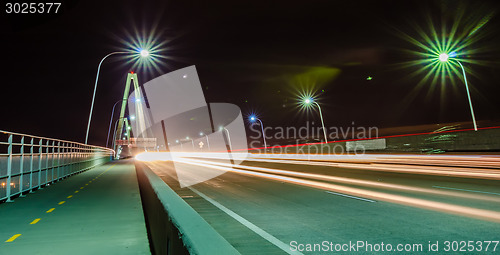 Image of traffic commute on bridge at night long exposure