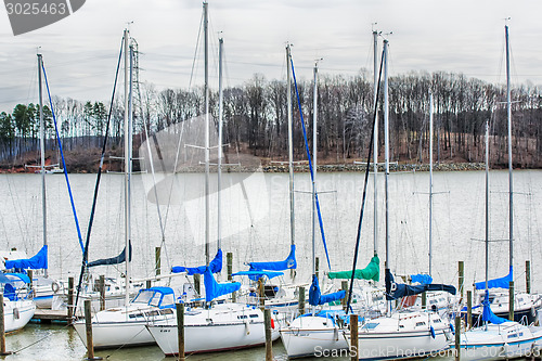 Image of parked yachts in harbour with cloudy skies