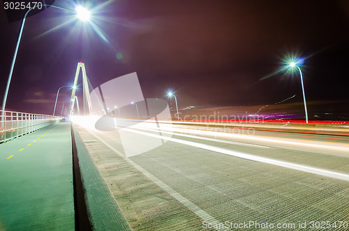 Image of traffic commute on bridge at night long exposure