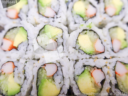 Image of sushi with salmon and avocado rolls