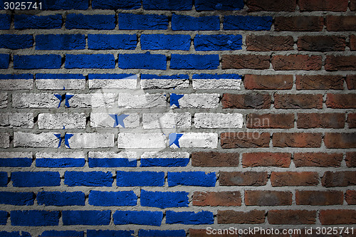 Image of Brick wall texture with flag