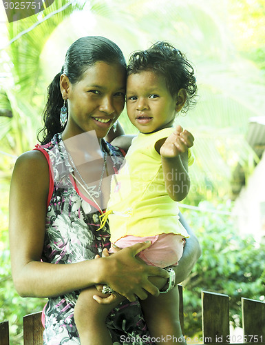 Image of editorial latina woman mother with baby daughter