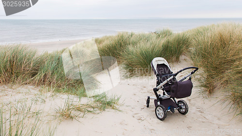 Image of Baby stroller standing at a beach 