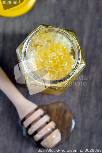 Image of honeycomb and honey in glass jars