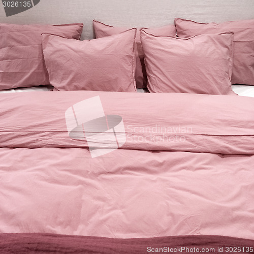 Image of Bed with pink bedclothes