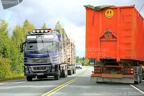 Image of Volvo FH16 Logging Truck and a Trailer Truck on the Road