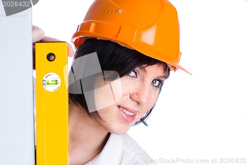 Image of Pretty girl in helmet with level