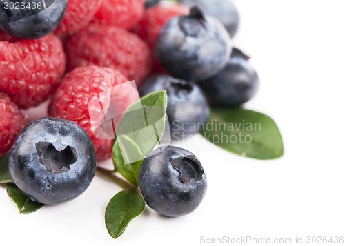 Image of Many blueberries, raspberries. Isolated white