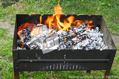 Image of Fire in a container for cooking meat