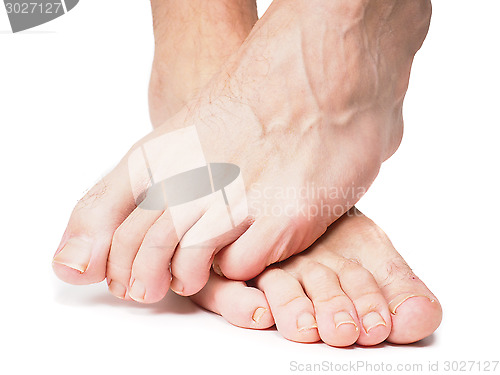 Image of Male feet on over the other isolated towards white