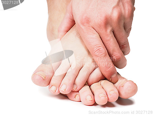 Image of Male person holding onto feet isolated towards white