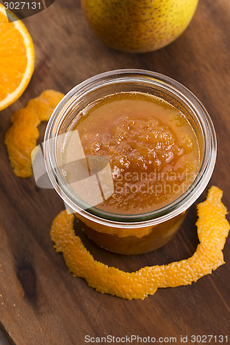 Image of glass of pear jam with orange