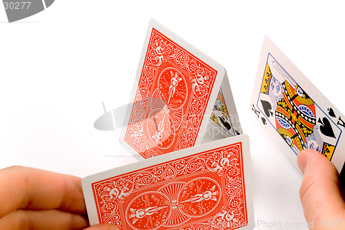 Image of Hands building a house of cards