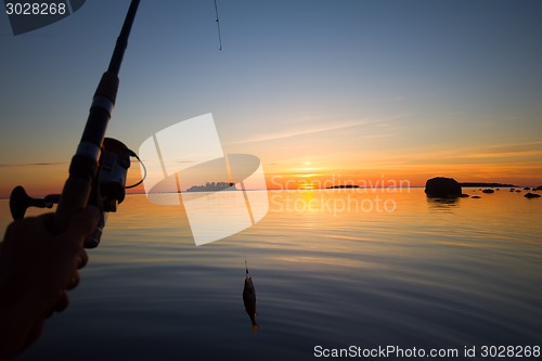 Image of Sunset river perch fishing with the boat and a rod