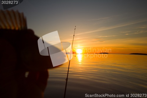 Image of Sunset river perch fishing with the boat and a rod