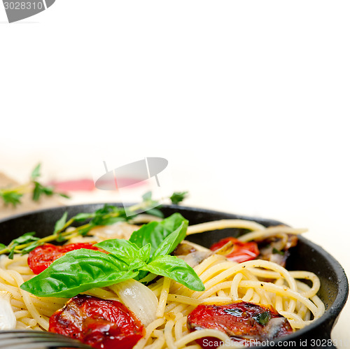 Image of spaghetti pasta with baked cherry tomatoes and basil 