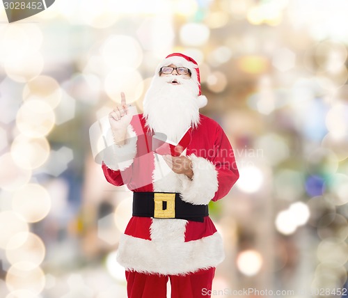 Image of man in costume of santa claus with notepad