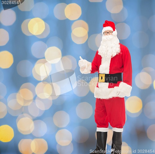 Image of man in costume of santa claus showing thumbs up