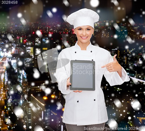 Image of smiling female chef with tablet pc blank screen