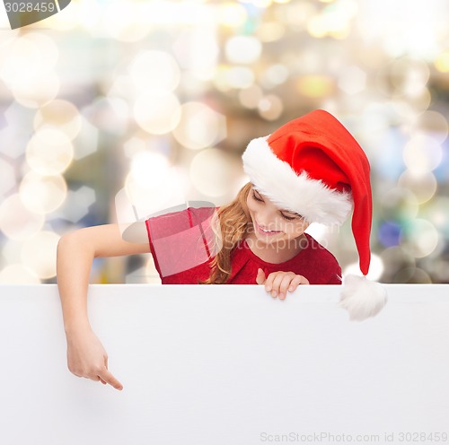 Image of girl in santa helper hat with blank white board