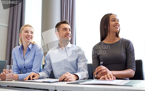 Image of smiling business people meeting in office