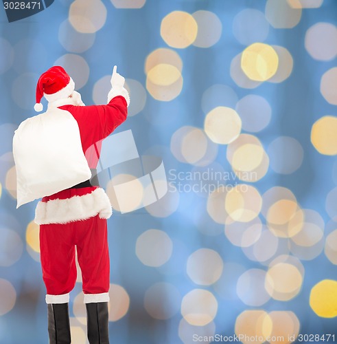 Image of man in costume of santa claus with bag