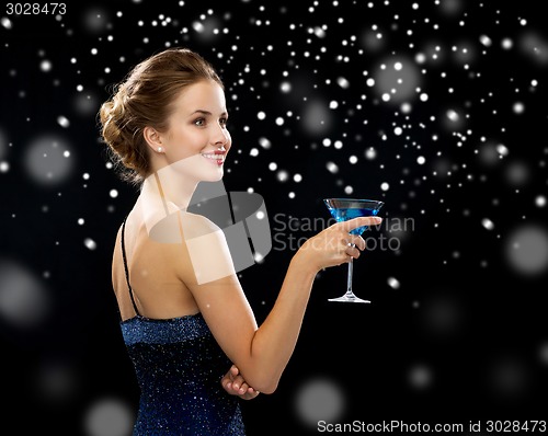 Image of smiling woman holding cocktail