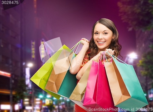 Image of smiling young woman with shopping bags