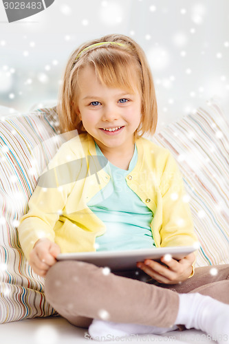 Image of smiling girl with tablet pc computer at home
