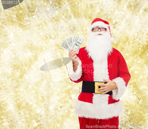 Image of man in costume of santa claus with dollar money