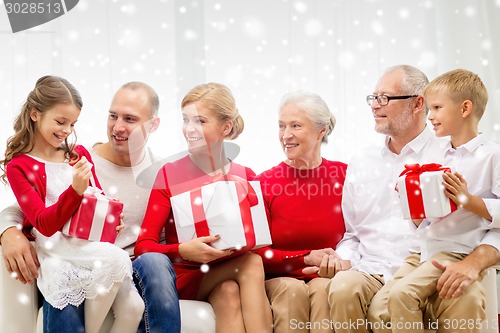 Image of smiling family with gifts at home