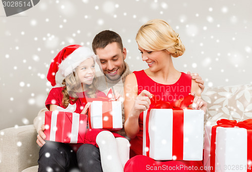 Image of smiling family holding many gift boxes