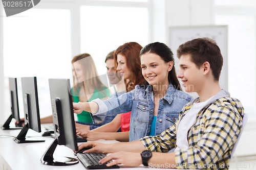 Image of male student with classmates in computer class