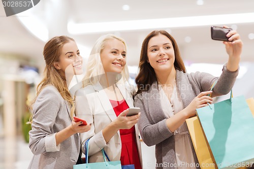 Image of women with smartphones shopping and taking selfie