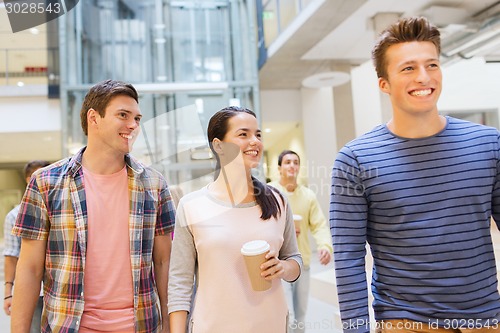 Image of group of smiling students with paper coffee cups