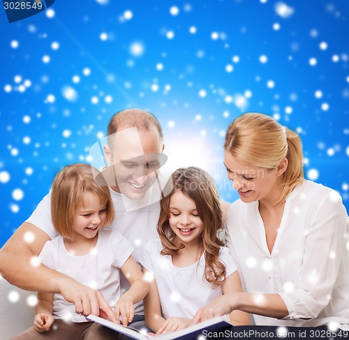 Image of happy family with book at home