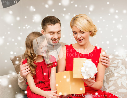 Image of smiling family looking into open gift box