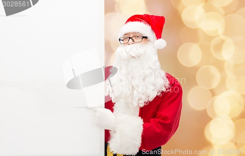 Image of man in costume of santa claus with billboard