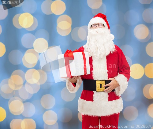 Image of man in costume of santa claus with gift box
