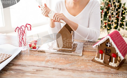 Image of close up of woman making gingerbread houses