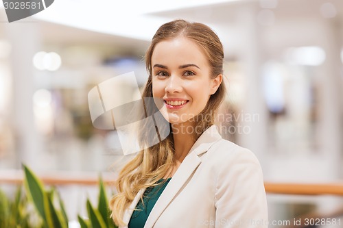 Image of happy young woman in mall or business center