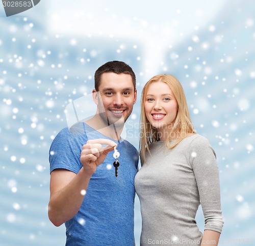 Image of smiling couple holding keys